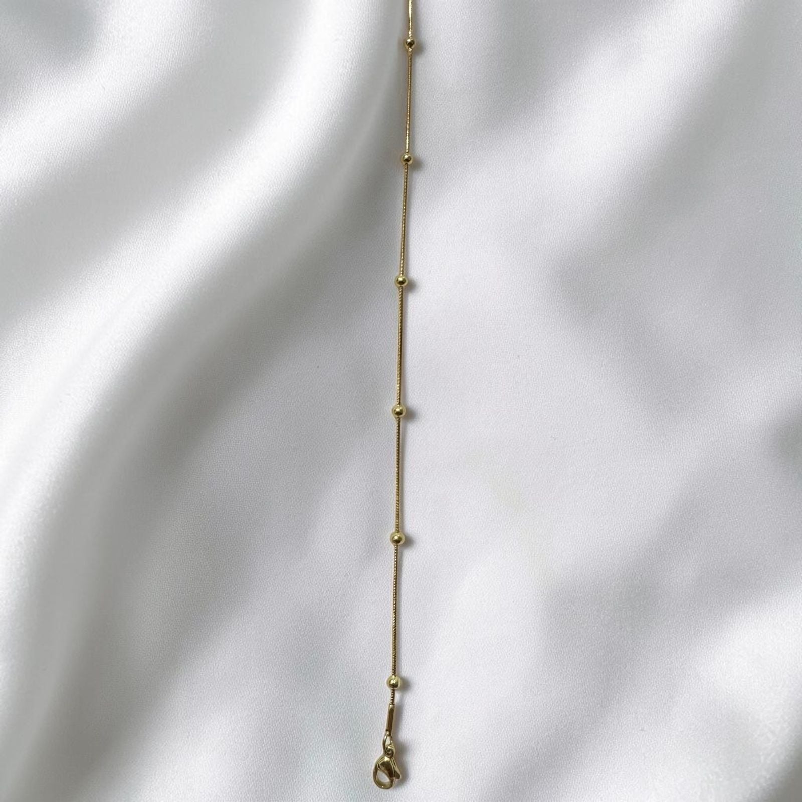 Minimalist Gilded Orb Strand